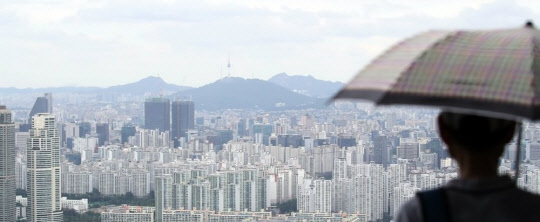 정부가 3기 신도시 등 대규모 택지 개발 토지보상을 앞둔 원주민들이 자신의 땅을 협의 양도했을 때, 해당 택지에서 공급되는 주택을 가구당 1채씩 특별공급 받을 수 있게 할 전망이다. 한 시민이 아파트 밀집 지역을 바라보고 있다.  연합뉴스